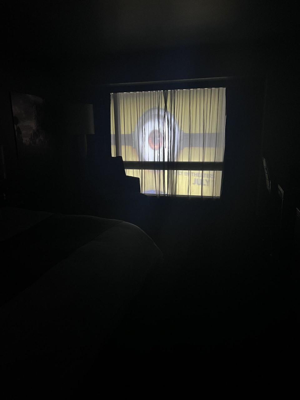 A giant eyeball looking into someone's window