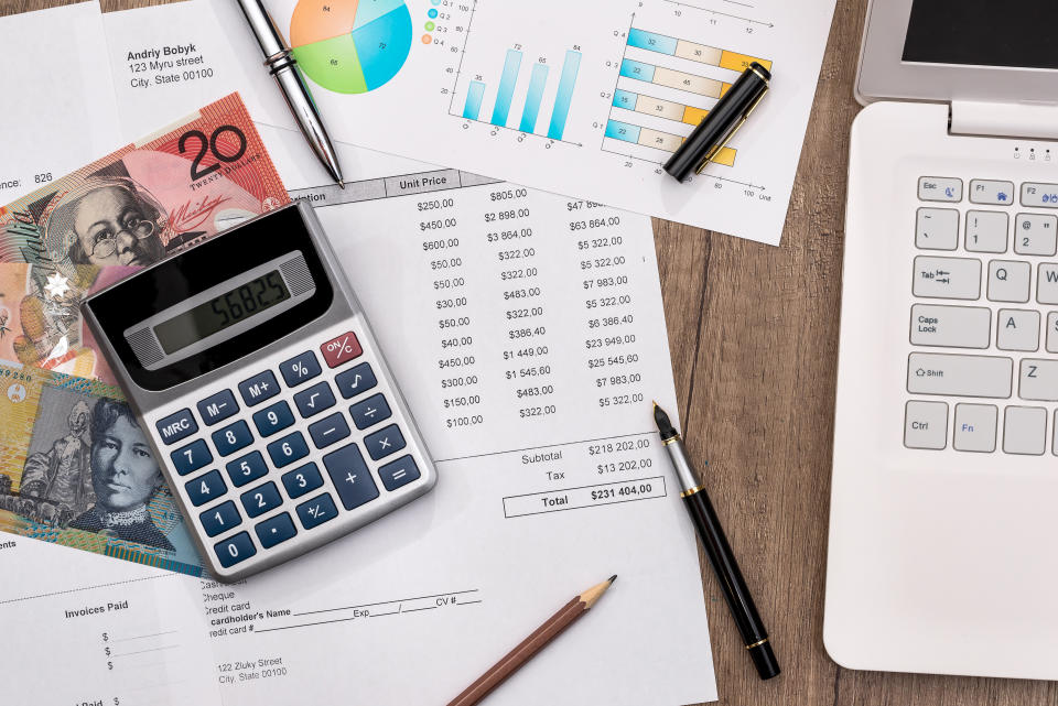 australian dollar with graph, home budget laptop and calculator