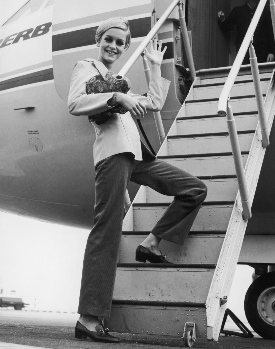 Twiggy boards an aircraft at London's Heathrow Airport, bound for Tunisia on an export drive for Berkertex.