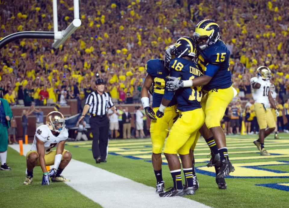 Sep 7, 2013; Ann Arbor, MI, USA; Michigan Wolverines defensive back Blake Countess (18) celebrates with linebacker James Ross III (15) and defensive back Delonte Hollowell (24) after intercepting a pass intended for Notre Dame Fighting Irish wide receiver Chris Brown (2) in the fourth quarter at Michigan Stadium. Michigan won 41-30. Mandatory Credit: Matt Cashore-USA TODAY Sports