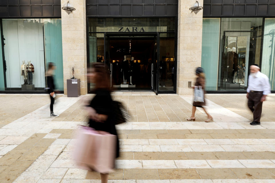 People walk past a Zara store in a shopping thoroughfare in Jerusalem October 24, 2022. REUTERS/Ammar Awad