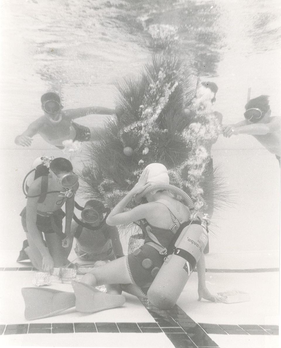 The Coral Divers decorating a Christmas Tree in the Yacht Club pool in 1962.