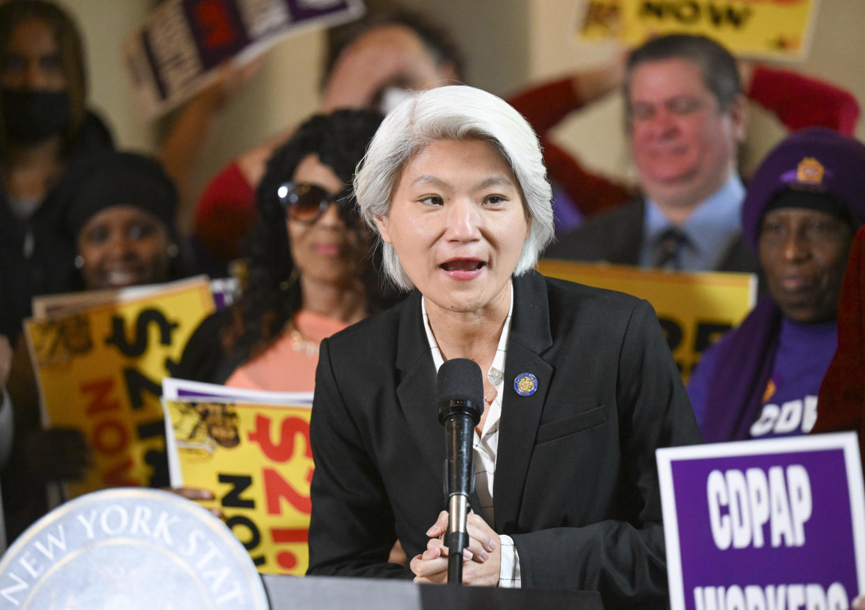 New York Sen. Iwen Chu, D-New York, stands with protesters urging lawmakers to raise New York's minimum wage during a rally at the state Capitol, Monday, March 13, 2023, in Albany, N.Y. (AP Photo/Hans Pennink)