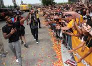 Cleveland Cavaliers Kyrie Irving celebrates with the crowd during a parade to celebrate winning the 2016 NBA Championship in downtown Cleveland, Ohio, U.S. June 22, 2016. REUTERS/Aaron Josefczyk