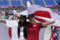 Gold medal winner Sakura Yosozumi, right, and silver medalist Kokona Hiraki, both of Japan, celebrate after the women's park skateboarding finals at the 2020 Summer Olympics, Wednesday, Aug. 4, 2021, in Tokyo, Japan. (AP Photo/Ben Curtis)