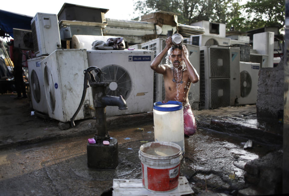 <p>An Indian migrant daily-wage worker bathes at a public well pump on a hot morning in New Delhi on May 17, 2016. Scorching summer temperatures, hovering well over 104 degrees Fahrenheit, are making life extremely tough for millions of poor people across north India. Without access to air conditioning or sometimes even an electric fan, they struggle to cope with the heat in their homes. (Altaf Qadri/AP)</p>