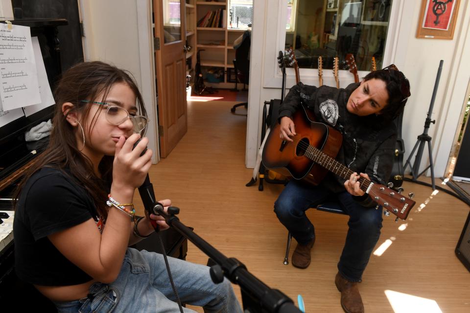 Aaron Lagesse, left, 12, sings along with music teacher Ella Hubley on March 18 at the alternate school program Rock Tree Sky, which is housed at Summit School in Ojai.