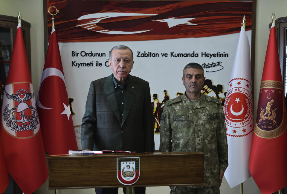 FILE - Turkey's President Recep Tayyip Erdogan, left, poses with a commander during his visit to the earthquake-hit city of Gaziantep, southern Turkey, Thursday, Feb. 9, 2023. Turkish President Recep Tayyip Erdogan came to power 20 years ago riding a wave of public outrage toward the previous government's handling of a deadly earthquake. Now, three months away from an election, Erdogan's political future hinges on how the public perceives his government's response to a similarly devastating natural disaster. (Turkish Presidency via AP, File)