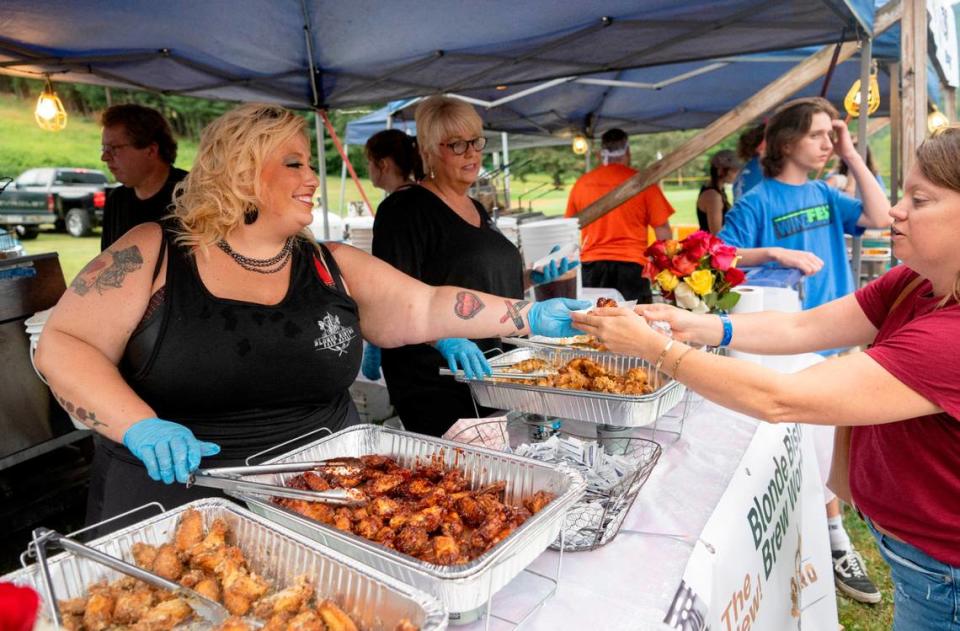 Ciara Semack from Blonde Bistro serves wings during the finals for WingFest at Tussey Mountain on Thursday, Aug. 4, 2022.