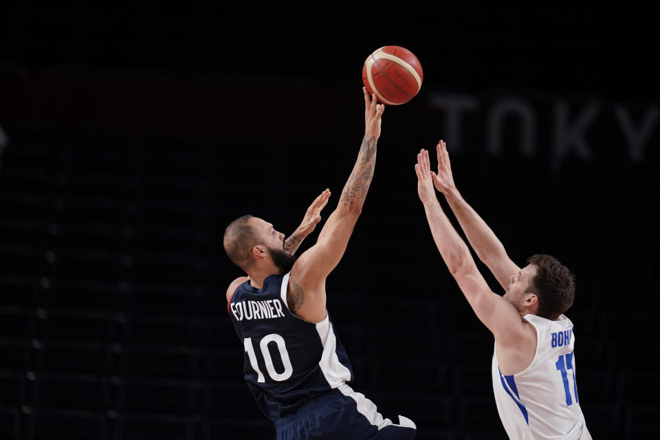 France's Evan Fournier (10) shoots on Czech Republic's Jaromir Bohacik (17) during a men's basketball preliminary round game at the 2020 Summer Olympics in Saitama, Japan, Wednesday, July 28, 2021. (AP Photo/Charlie Neibergall)