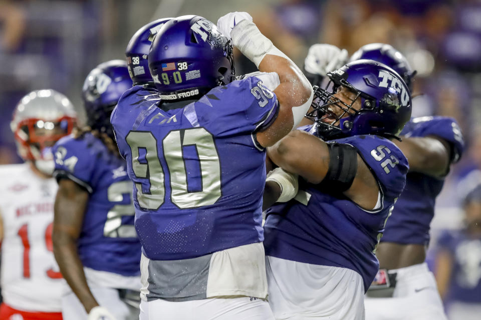 TCU defensive linemen Caleb Fox (90) and Damonic Williams (52) celebrate Williams' sack during the first half of an NCAA college football game against Nicholls State, Saturday, Sept. 9, 2023, in Fort Worth, Texas. (AP Photo/Gareth Patterson)