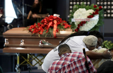 Mourners embrace before the funeral services for police shooting victim, Stephon Clark at Bayside Of South Sacramento Church, in Sacramento, California, March 29, 2018. Jeff Chiu/Pool via Reuters