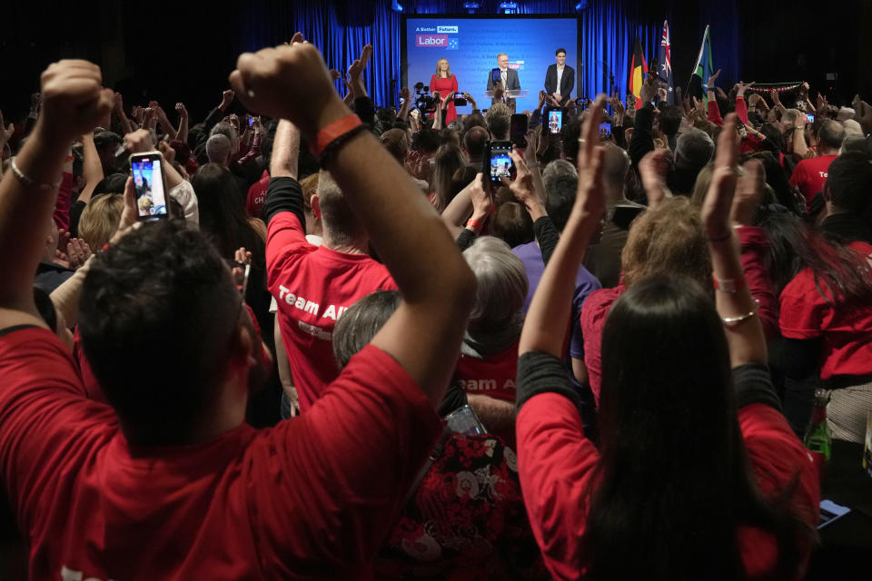 Labor Party leader Anthony Albanese, center back, speaks to supporters at a Labor Party event in Sydney, Australia, Sunday, May 22, 2022, after Prime Minister Scott Morrison conceding defeat to Albanese in a federal election. (AP Photo/Rick Rycroft)