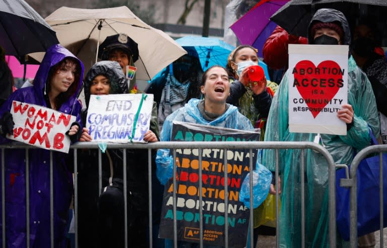 Pro abortion rights activists hold placards during the annual anti-abortion demonstration in New York City, on March 23, 2024 (Kena Betancur)
