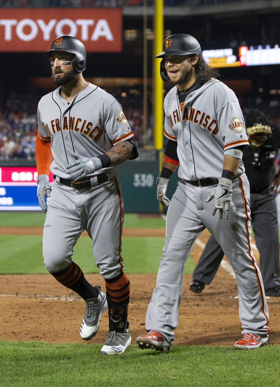 San Francisco Giants' Kevin Pillar, left, and Brandon Crawford return to the dugout after scoring on Pillar's home run during the sixth inning of the team's baseball game against the Philadelphia Phillies, Wednesday, July 31, 2019, in Philadelphia. (AP Photo/Chris Szagola)