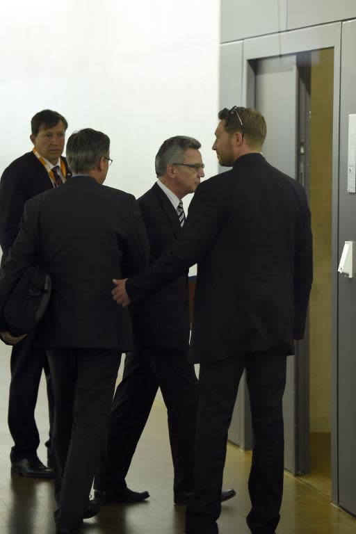 German Interior Minister Thomas de Maiziere (2nd right) enters a room to face a secret services oversight panel on May 6, 2015 in Berlin