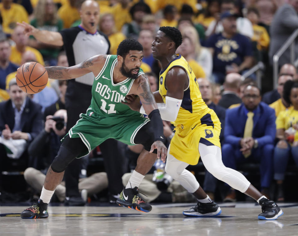 Boston Celtics guard Kyrie Irving (11) drives on Indiana Pacers guard Darren Collison (2) during the second half of Game 4 of an NBA basketball first-round playoff series in Indianapolis, Sunday, April 21, 2019. The Celtics defeated the Pacers 110-106 to win the series 4-0. (AP Photo/Michael Conroy)