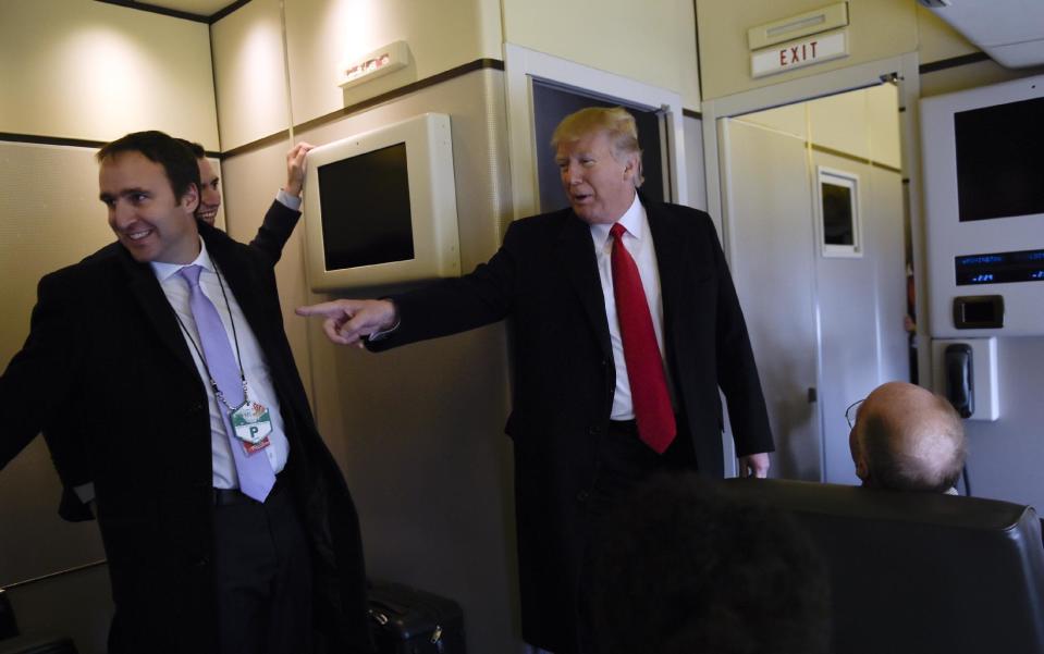 President Donald Trump speaks to reporters on Air Force One while traveling to Palm Beach International Airport in West Palm Beach, Fla., Friday, Feb. 3, 2017. Trump is spending the weekend at Mar-a-Lago. (AP Photo/Susan Walsh)