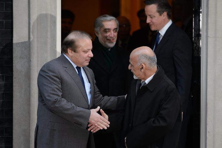 Afghan President Ashraf Ghani (R) shakes hands with Pakistan's Prime Minister Nawaz Sharif following a meeting with British Prime Minister David Cameron (R, back), at No. 10 Downing Street in London, on December 5, 2014