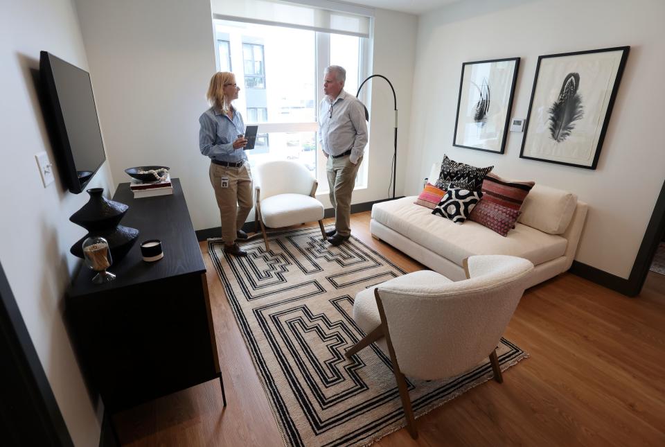 Claudia O’Grady, vice president of Multifamily Finance, and Cleon Butterfield, Utah Housing Corporation CFO, look around a two-bedroom apartment in The Aster, a three-building development that includes low-income housing, commercial and public spaces, in Salt Lake City on Tuesday, May 2, 2023. | Kristin Murphy, Deseret News