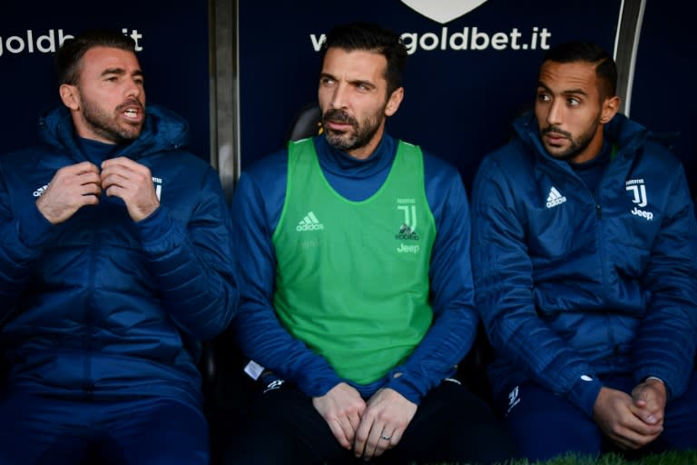 L-R: Juventus' defender Andrea Barzagli, goalkeeper Gianluigi Buffon and defender Medhi Benatia are pictured on the bench on November 19, 2017 at the 'Luigi Ferraris' Stadium in Genoa