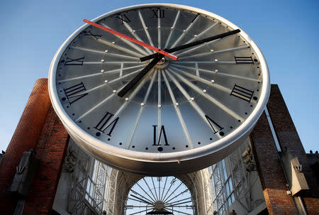 FILE PHOTO: A giant clock is seen over the entrance of Cergy-Saint-Christophe railway station in Cergy, near Paris, France, September 19, 2018. REUTERS/Christian Hartmann/File Photo