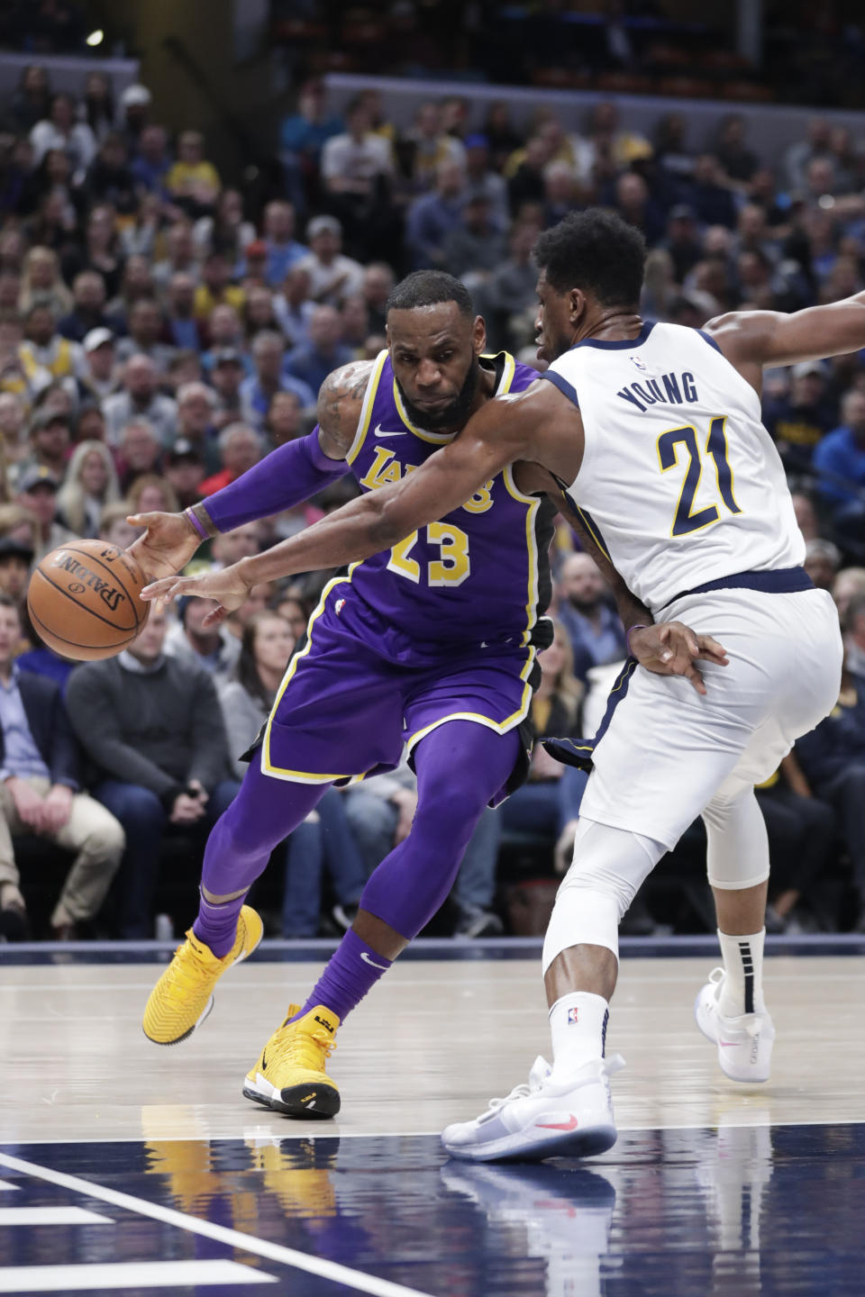 Los Angeles Lakers forward LeBron James (23) drives on Indiana Pacers forward Thaddeus Young (21) during the first half of an NBA basketball game in Indianapolis, Tuesday, Feb. 5, 2019. (AP Photo/Michael Conroy)