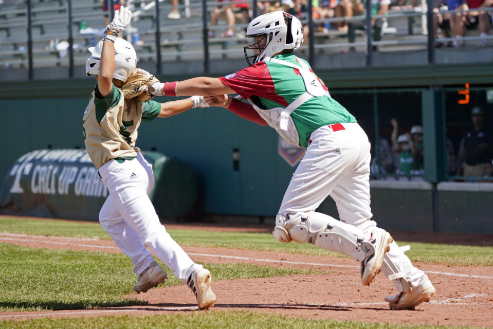 Taiwan's Chen Po-Chun (5) is tagged out as he attempted to score on a ball hit by Liao Yuan-Shu by Mexico catcher Fernando Garcia during the fourth inning of a baseball game at the Little League World Series tournament in South Williamsport, Pa., Wednesday, Aug. 24, 2022. Taiwan won 5-1. (AP Photo/Tom E. Puskar)
