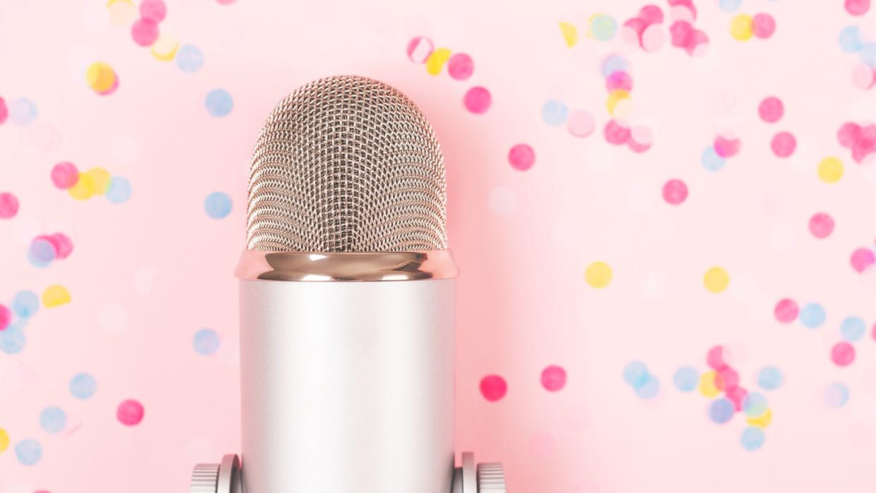  Podcast microphone in front of pink background with confetti. 