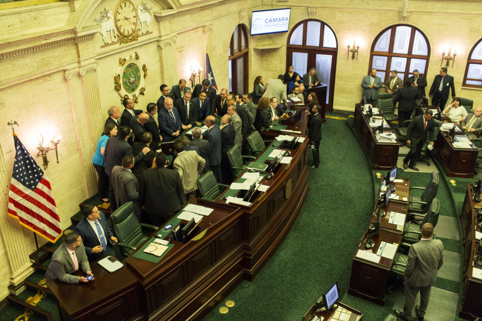 Puerto Rico's House of Representatives prepare to vote on whether to confirm Pedro Pierluisi as secretary of state, in San Juan, Puerto Rico, Friday, Aug. 2, 2019. The confirmation removes an important obstacle to him becoming governor. But Pierluisi's fate remains unclear. (AP Photo/Dennis M. Rivera Pichardo)