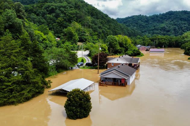 Homes along Gross Loop off of KY-15 are flooded with water from the North Fork of the Kentucky River in Jackson, Kentucky, on July 28. (Photo: Arden S. Barnes/For The Washington Post/Getty Images)