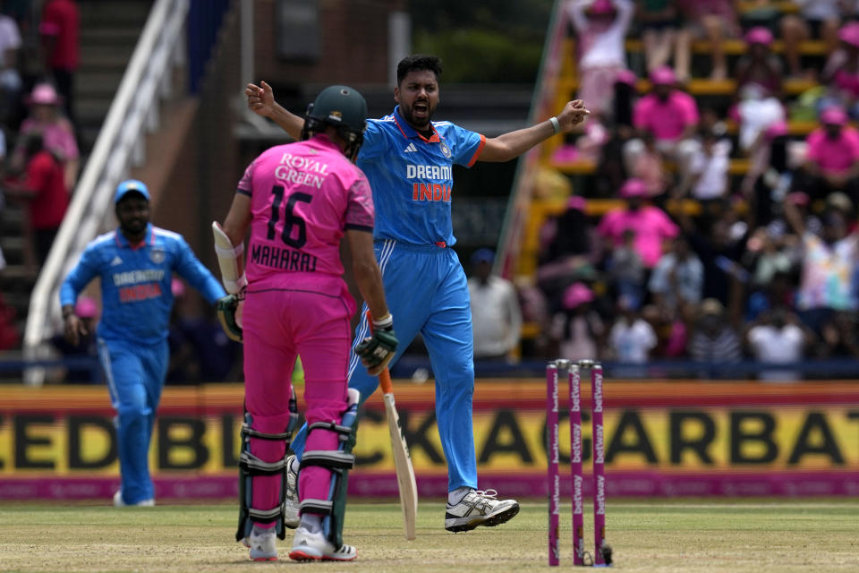 India's bowler Avesh Khan, right, celebrates after South Africa's Keshav Maharaj for 4 runs during the first One Day International cricket match between South Africa and India, at the Wanderers in Johannesburg, South Africa, Sunday, Dec. 17, 2023. (AP Photo/Themba Hadebe)