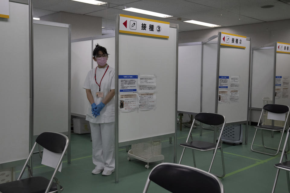A nurse waits to inoculate people with the Moderna coronavirus vaccine at the newly-opened mass vaccination center in Tokyo Monay, May 24, 2021. Japan opened mass-vaccination sites in two of the country’s biggest metropolitan areas, Tokyo and Osaka, with the goal of administering the shots to up to 15,000 elderly people a day. The Japanese plates at top read: "Inoculation." (Carl Carl Court/Pool Photo via AP)
