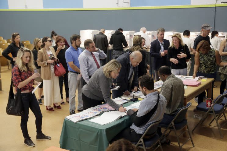 On Election Day 2016, people vote at a polling place set up at the Kenter Canyon Elementary School in Los Angeles. (AP Photo/Nick Ut, file)