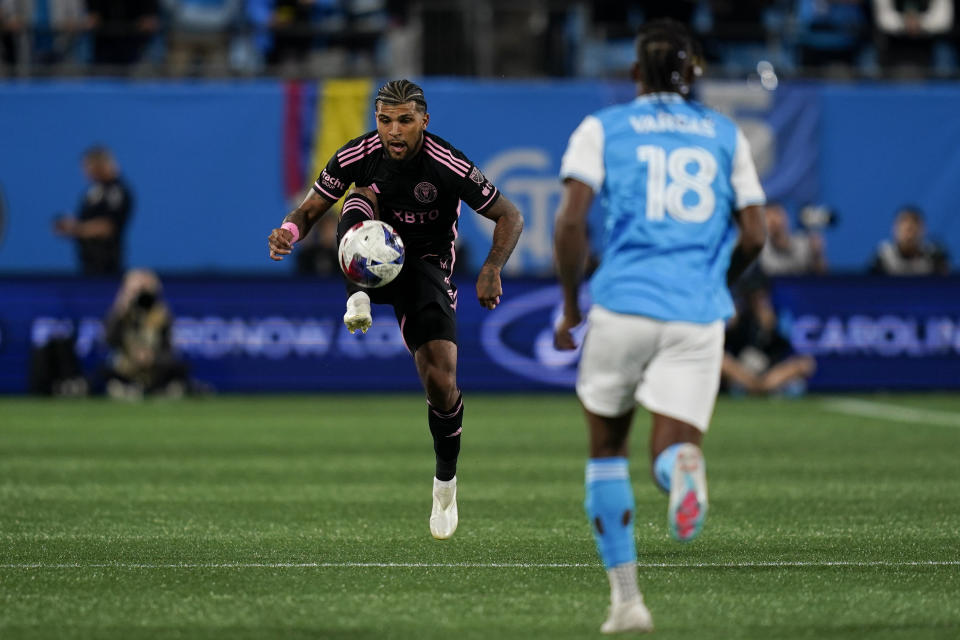 Inter Miami defender DeAndre Yedlin, left, brings the ball down during the second half of an MLS soccer match against Charlotte FC, Saturday, Oct. 21, 2023, in Charlotte, N.C. (AP Photo/Erik Verduzco)