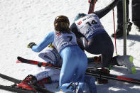 United States' Mikaela Shiffrin, gold in an alpine ski World Championships giant slalom, lies on the ground as silver medalist Italy's Federica Brignone and bronze medalist Norway's Ragnhild Mowinckel celebrate with her, in Meribel, France, Thursday, Feb. 16, 2023. (AP Photo/Gabriele Facciotti)