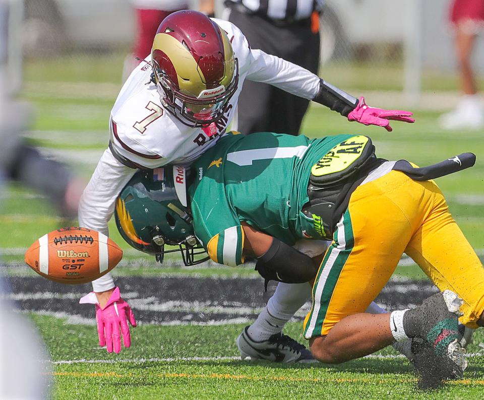 Garfield receiver Calvin Bibbs is separated from the ball by Firestone defender Juelz Causby on Sept. 23 in Akron.