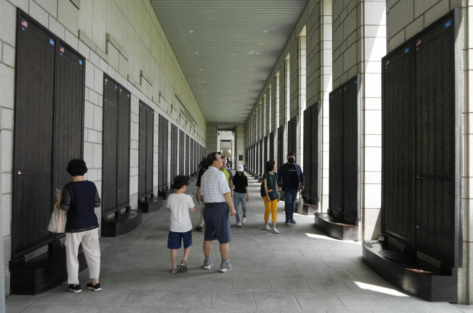 Visitors look at the names of foreign soldiers who died during the Korean War at the Korea War Memorial Museum in Seoul, South Korea, Tuesday, July 25, 2023. The truce that stopped the bloodshed in the Korean War turns 70 years old on Thursday, July 27, 2023 and the two Koreas are marking the anniversary in starkly different ways, underscoring their deepening nuclear tensions. (AP Photo/Ahn Young-joon)