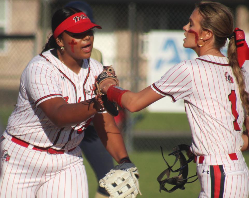 Baldwin pitcher Shaylen Byrd (1) and third base Jazmine Ramos-Merced (21) fist-bump in celebration after escaping a bases-loaded jam in the Gateway Conference softball final against Paxon on April 11, 2024. [Clayton Freeman/Florida Times-Union]