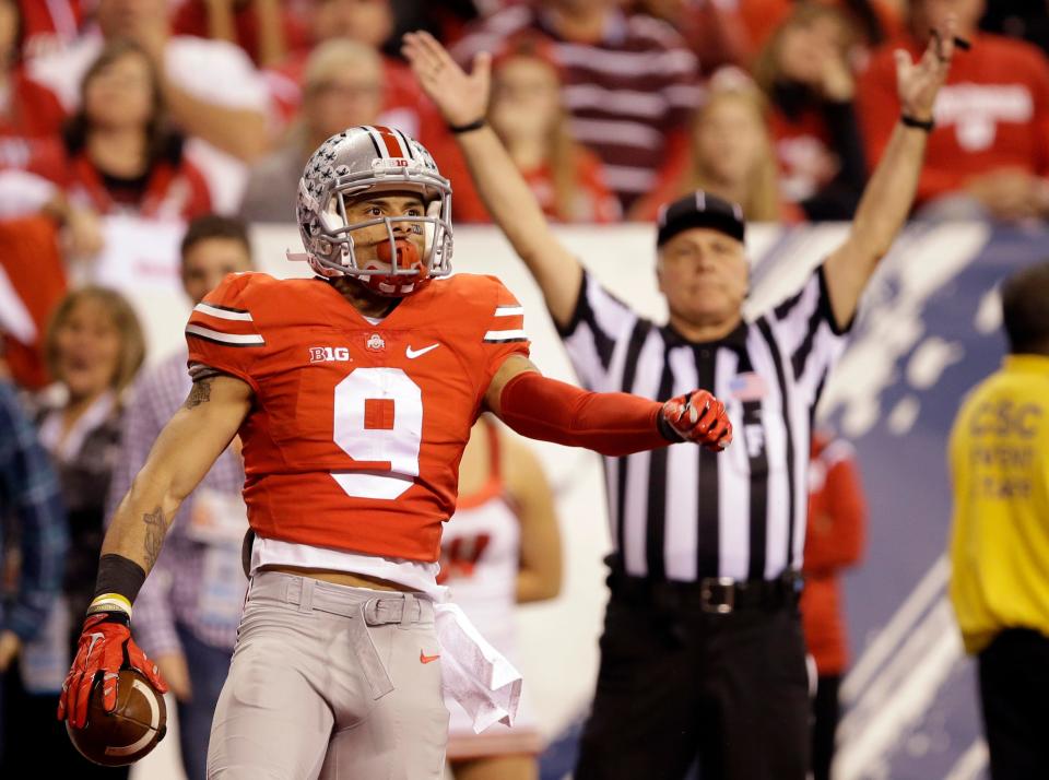 Ohio State wide receiver Devin Smith celebrates after catching a 44-yard touchdown pass during the first half of the Big Ten championship game against Wisconsin, Saturday, Dec. 6, 2014, in Indianapolis.