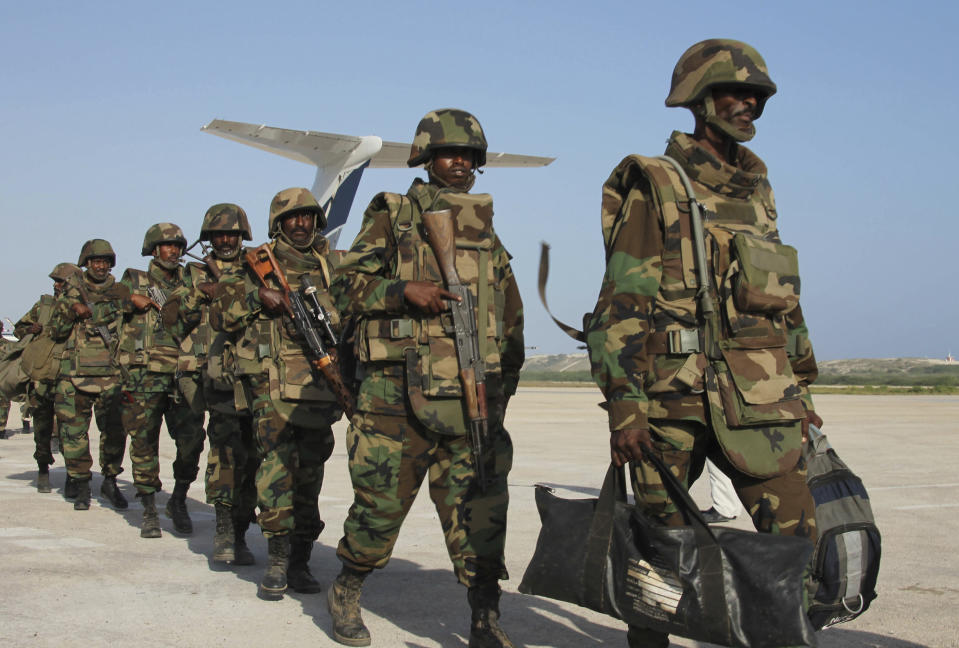 FILE - Djiboutian forces walk inline during their arrival in Mogadishu, Somalia, on Dec. 20, 2011. The United Nations Security Council on Thursday Nov. 9, 2023 suspended for a period of three months the pullout of African Union troop from Somalia, where fighting rages with al-Qaida’s affiliate in East Africa. The decision follows a request by the Horn of Africa nation for the forces to remain in the country to help in the fight against the al-Shabab extremists. (AP Photo/Farah Abdi Warsameh, File)