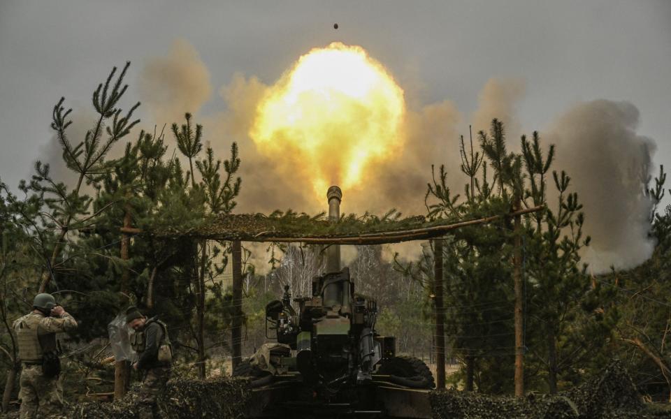 Ukrainian servicemen fire with a TRF-1 155mm at Russian positions - ARIS MESSINIS/AFP