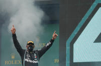 Mercedes driver Lewis Hamilton of Britain celebrates on the podium after winning the Turkish Formula One Grand Prix at the Istanbul Park circuit racetrack in Istanbul, Sunday, Nov. 15, 2020. (Murad Sezer/Pool via AP)