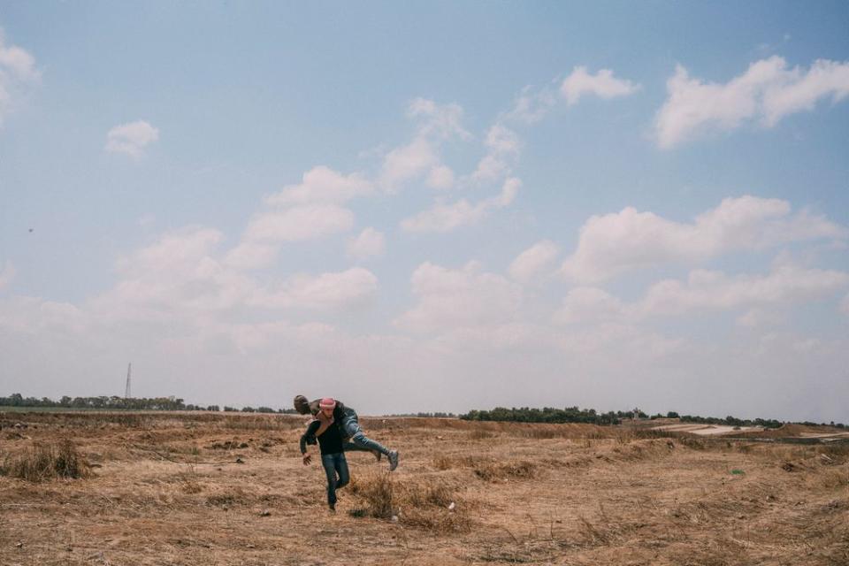 A wounded demonstrator is carried away during the protest along the Gaza-Israel border.