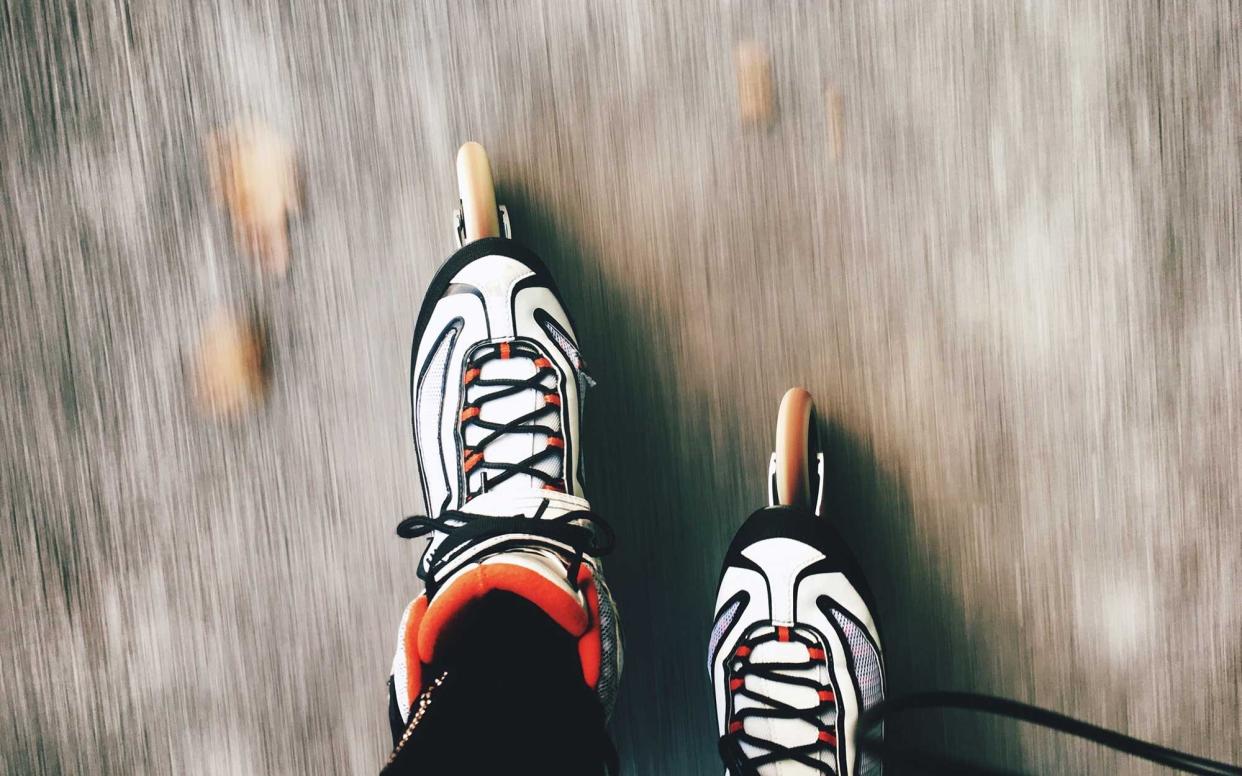 Low Section Of Person Inline Skating On Road