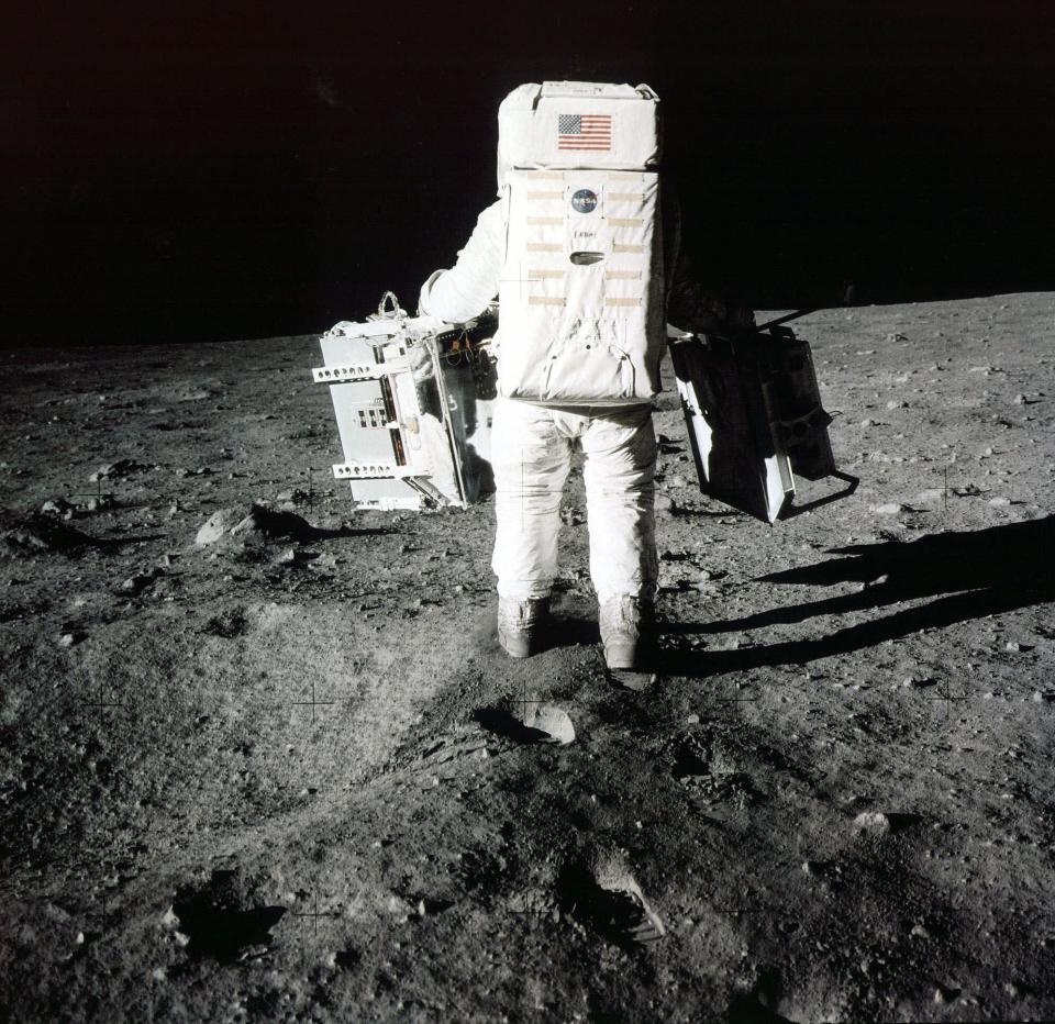 Buzz Aldrin carries scientific experiments to a deployment site south of the lunar module Eagle, July 20, 1969. Photo was taken by Neil Armstrong of the Apollo 11 mission. | Neil Armstrong/AP