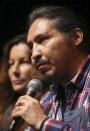 Athabasca Chipewyan First Nation (ACFN) Chief Allan Adam addresses the media before musician Neil Young's "Honor The Treaties" concert series at the Centennial Concert Hall in Winnipeg, Manitoba, January 16, 2014. Young is touring to raise money for the aboriginal group, which is trying to prevent the expansion of tar sands development. At left is Doreen Somers, ACFN Industry Relation Corporation Consultation Coordinator. REUTERS/Trevor Hagan (CANADA - Tags: POLITICS ENTERTAINMENT ENVIRONMENT ENERGY SOCIETY)