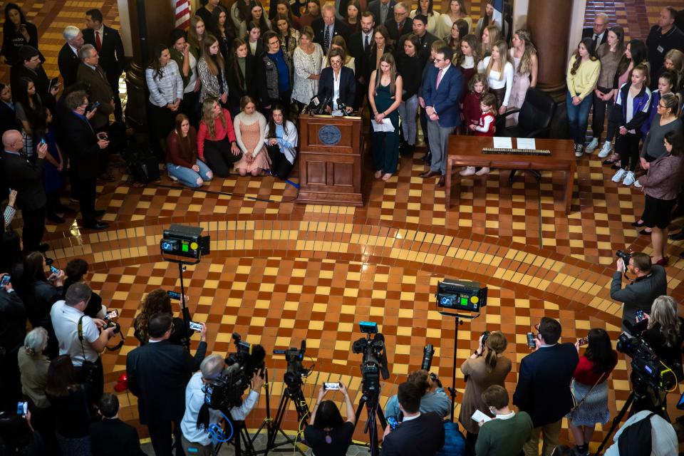 Gov. Kim Reynolds gives remarks before signing House File 2416 into law, prohibiting transgender women and girls from competing in female sports offered by Iowa schools, colleges and universities, on Thursday, March 3, 2022, in the rotunda of the Iowa State Capitol, in Des Moines. 