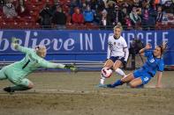 U.S. midfielder Kristie Mewis (22) and Iceland defender Gudrun Arnardottir (18) watch as Iceland goalkeeper Sandra Sigurdardottir (1) reaches to stop Mewis' shot during the first half of a SheBelieves Cup soccer match Wednesday Feb. 23, 2022, in Frisco, Texas. (AP Photo/Jeffrey McWhorter)