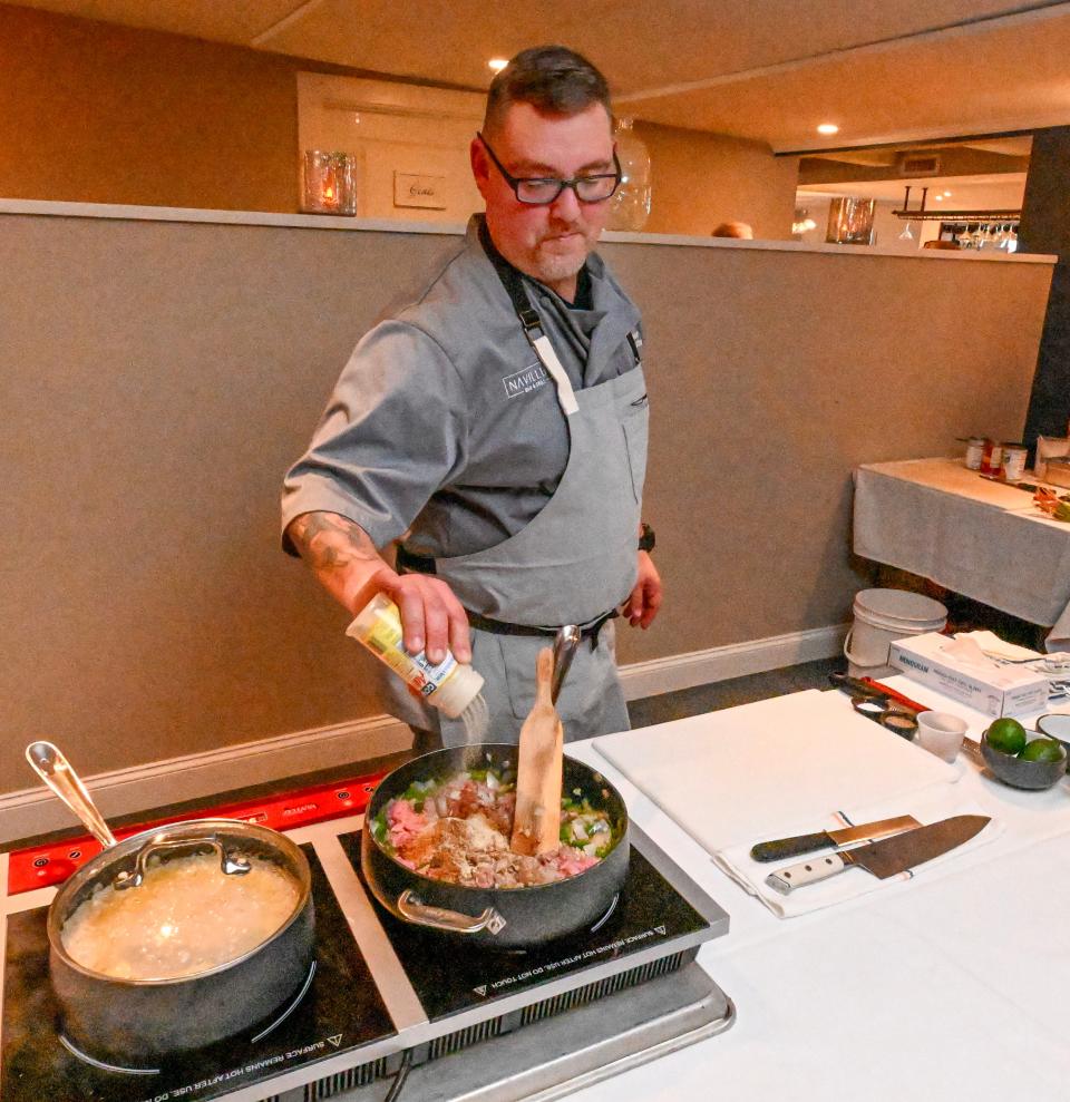 Julio Lazzarini, head chef at Navillus in Orleans seasons his turkey and Spam chili at the Lower Cape Outreach Council chef competition for affordable meals at Pate's Restaurant in Chatham. Lazzarini's recipe was the top entry.